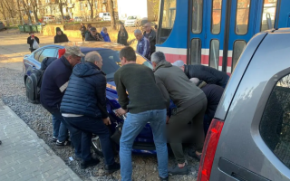 В Киеве мужчины собственноручно оттащили автомобиль, парализовавший движение трамваев